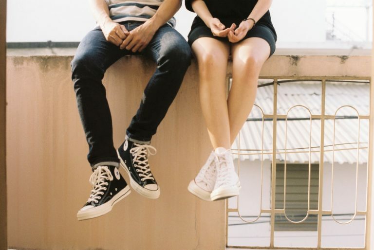 a person sitting on a window sill