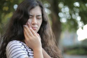 a woman with her hand on her face